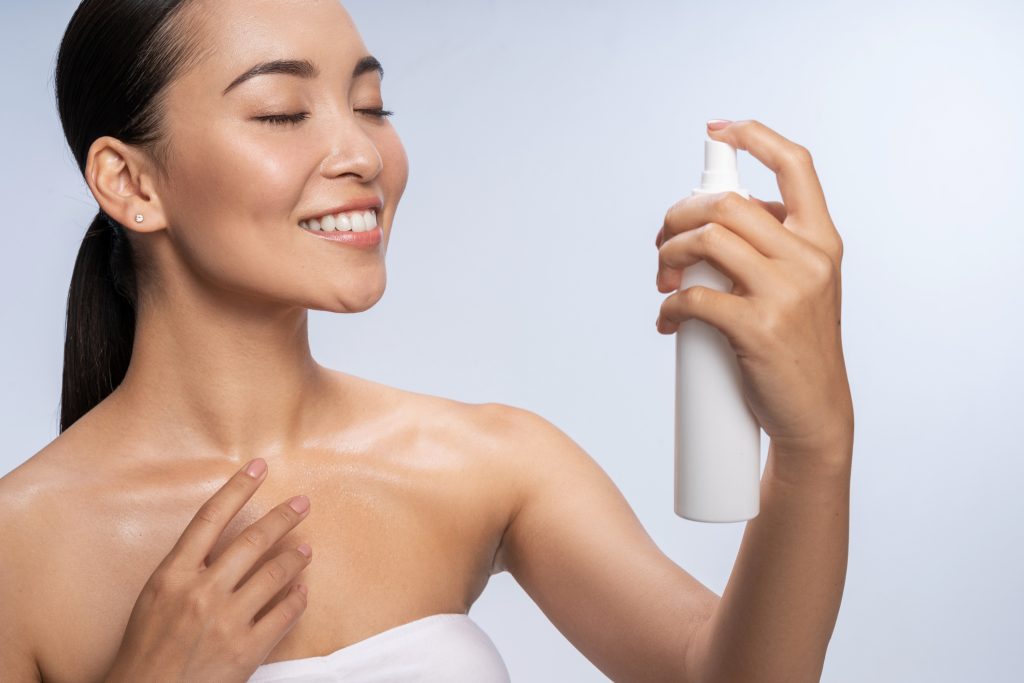 Woman uses setting spray to make sure her makeup stays on all day