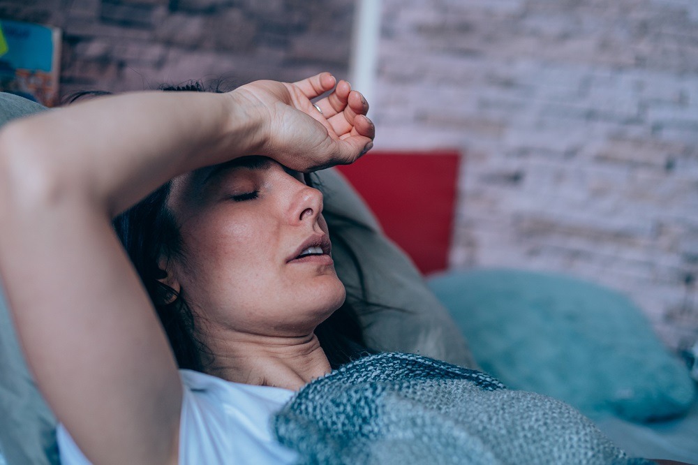 woman in bed with a headache