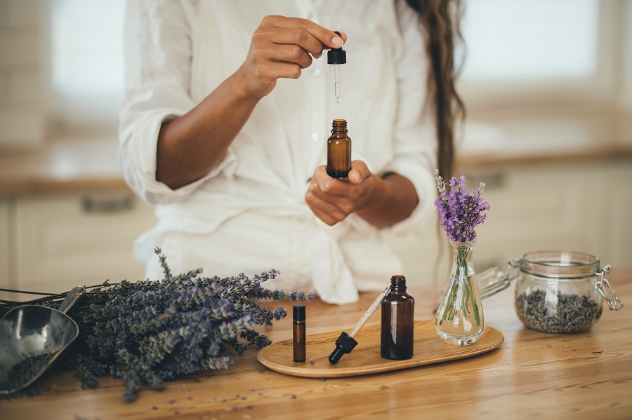 Woman in white shirt tests out a range of essential oils