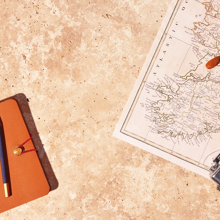 map and notebook on concrete background 